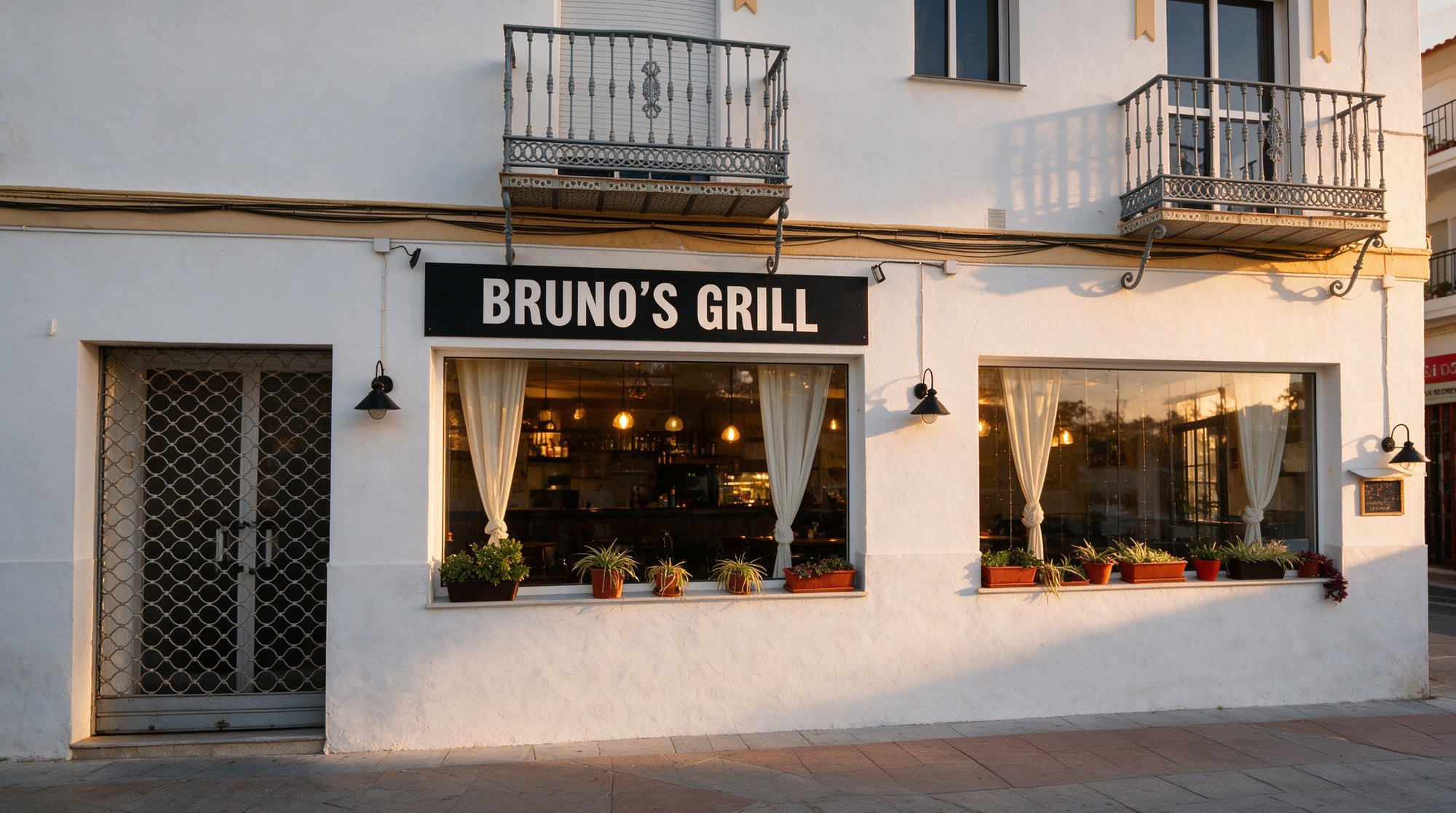 Fachada nocturna de Bruno's Grill en la calle Huertos, Nerja, con el letrero BRUNO'S GRILL iluminado